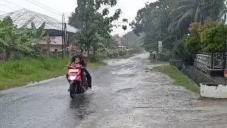 HEAVY RAIN TRAVEL ON THE ROAD SIDE IN CENTRAL JAVA INDONESIA