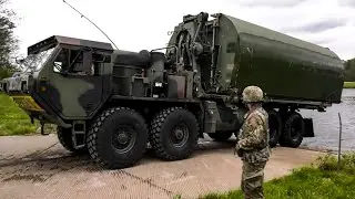 US Army Builds floating bridge to transport various military vehicles across the River