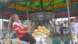Alice and Karson riding the Merry-Go-Round at Warren County Fair on 07/18/24