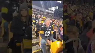 raven fan throws beer to a steeler fans face