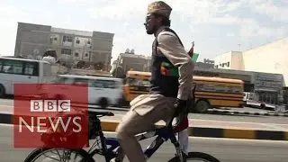 Riding a bike backwards around the world for peace - BBC News
