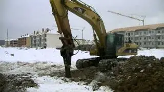 Cat 330C L with hydraulic hammer breaking frozen dirt