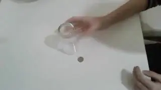 Magic trick. Glass and disappearing coin.