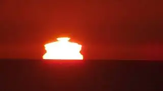 A complex sunset mirage with some green flashes