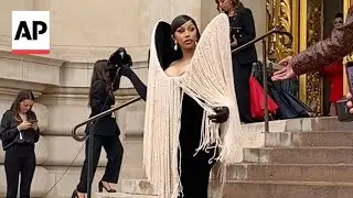 Cardi B holds a live crow at Schiaparelli's show at Paris Fashion Week