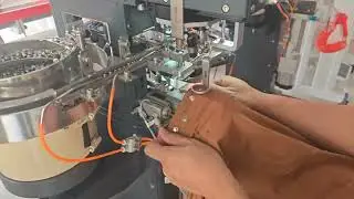automatic jacket snap button attaching machine. one machine do all sizes by changing button die