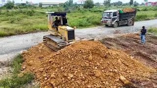 Land Filling Operation Begins Professional dozer operator and 6-wheel dump truck drivers moving soil