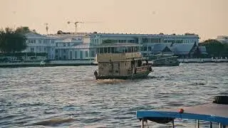 Old traditional ferry boat sailing on Chao Phraya River in Bangkok, Thailand. Urban cityscape with