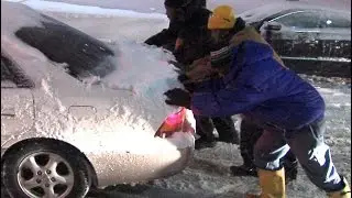 RTA bus passengers help push cars up an icy hill on Fairhill near East 124 in Cleveland