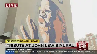 People gather at the John Lewis mural in downtown Atlanta to pay respects to the Civil Rights icon