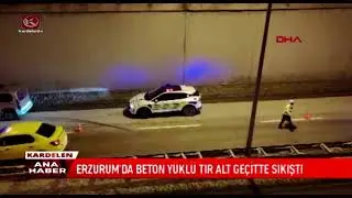 A TRUCK CARRYING CONCRETE GOT STUCK IN AN UNDERPASS IN ERZURUM.