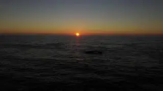 Mesmerizing Drone footage flying sideways at sunset over Black Sands Beach