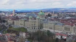 Tripod view from a unique aerial perspective of Swiss Federal Palace gleaming against historic Bern