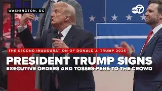 President Trump signs executive orders and then tosses pens to the crowd