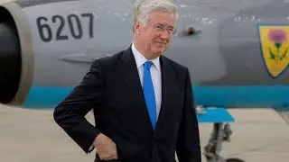 The Latest UK defense chief resigns after improper behavior