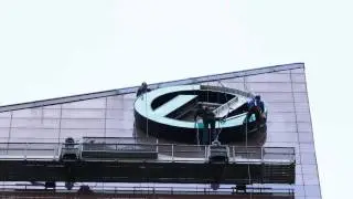 Morales Signs removes a sign from a high rise building using rope access