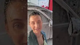 Hand car wash self-service girl washes her car well