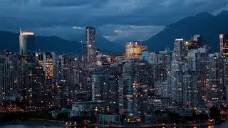 High wide time-lapse of downtown from False Creek, light changing from evening to dusk