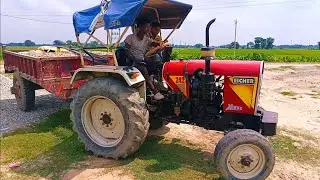 Eicher 242 fully loaded tractor trolley transporting gravel and cement steel