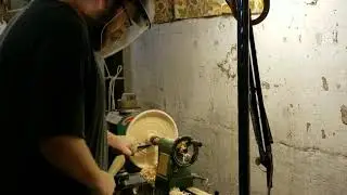 Working on a shallow bowl.