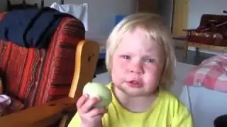 Kid eats onion like an apple