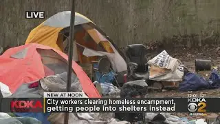 City workers begin clearing out homeless encampment on North Side