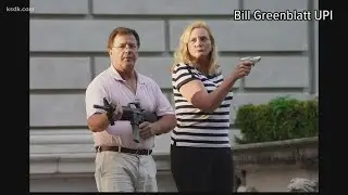 Couple points guns at protesters marching in Central West End to call for Mayor Krewson to resign