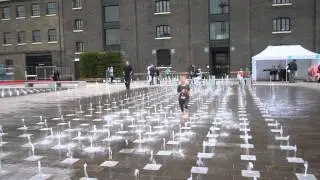Cute kid dancing with fountains
