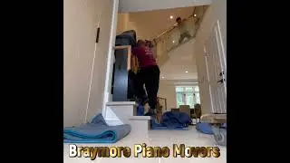 Braymore Piano movers moving an upright Piano up a flight of stairs in Barrie Ontario ￼