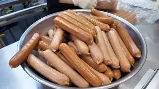 Inside a street food setup grilling sausages at scale