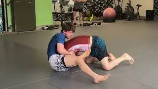 ￼ Two competition white belts work their half guard passing at open mat
