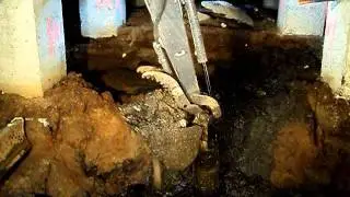 Limited access excavation underneath a wharf