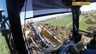 Caterpillar 963K tracked loader stripping dirt. In-cab footage