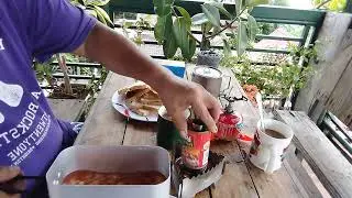 cooking in mess tin / triangle alcohol stove / pork n beans.