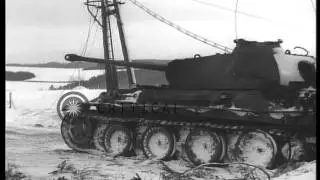 M-4 tank with dozer blade clearing snow from road and medics carry two wounded me...HD Stock Footage