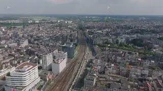 Aerial perspective of Antwerp, Belgium showcasing a modern cityscape with train tracks cutting