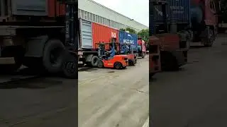 2 forklifts unload containers