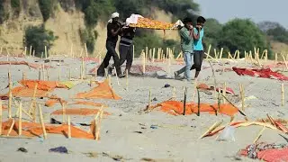 India: Covid victims' bodies buried in shallow mass graves along banks of River Ganges
