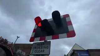 Poole level crossing  ￼ red lights, flashing, and barriers raised up 