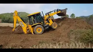 Jcb working near a paddy field