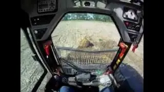 JCB 300T ECO Skid Loader moving a big rock and some trees on the farm 5-18-12