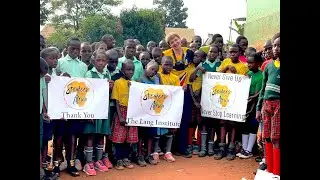 Peyton Thomas (Executive Director) greets students of the Uganda Youth Aid School, Kampala, Uganda.