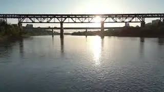 Cinematic Golden Hour Sunset Over River With Industrial Steel Truss Bridge Video