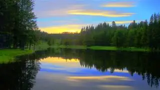Thin clouds reflecting off a serene lake
