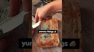 spreads parsley-garlic butter on ciabatta bread