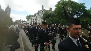 Combined pipe bands and dignitaries marching to open the  games.