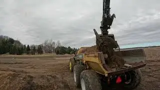 Deere 245 loading out barn foundation