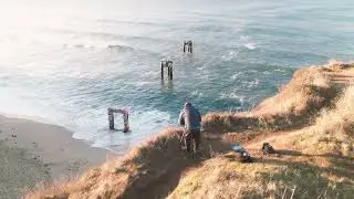 Chris Van Atta creating art on a coastal cliff