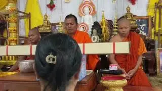 Bring alms to the monks at Wat Maha Leap.