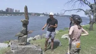 Local Artist Creating Balanced Rock Art In Riverside Park